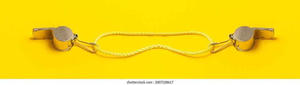 Sports Whistle On Yellow Background. Basketball, Handball, Futsal, Volleyball, Soccer, Baseball, Football And Hockey Referee Whistle