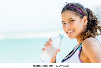 Sports Woman Drinking Water From A Bottle Outdoors