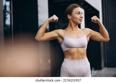 Sports Woman Showing Her Biceps Muscles