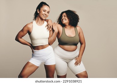 Sports women of different body types stand side by side, wearing fitness attire. Female athletes showing pride in their commitment to a fit and active lifestyle through training and exercise. - Powered by Shutterstock