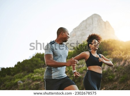 Sports, workout and couple walking by a mountain training for a race, marathon or competition. Fitness, nature and athletes doing an outdoor cardio exercise for health, energy and endurance at sunset
