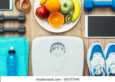 Sports and workout equipment, digital tablet and fruit on a wooden table, training and healthy lifestyle concept, flat lay - Shutterstock ID 505757590