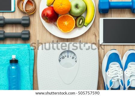 Sports and workout equipment, digital tablet and fruit on a wooden table, training and healthy lifestyle concept, flat lay