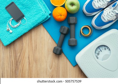 Sports And Workout Equipment On A Wooden Floor With Healthy Snacks, Weight Loss And Physical Activity Concept