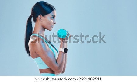 Sports, workout and female with weights in studio for arm or strength training with motivation. Fitness, exercise and Indian woman athlete with dumbells isolated by blue background with mockup space.