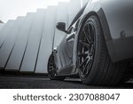 Sportscar with sporty wheels with a nice abstract background. Excellent wallpaper.