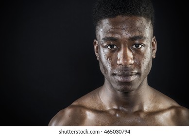 Sportsman athlete head shot sweating wet face after exercise portrait intense look close up isolated  black