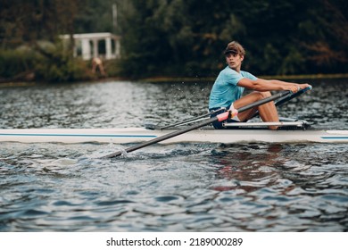 Sportsman athlete single scull man rower rowing technique on boat. Paddle oar splash movement - Powered by Shutterstock