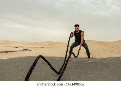 Sportsman battling ropes in the desert - Powered by Shutterstock