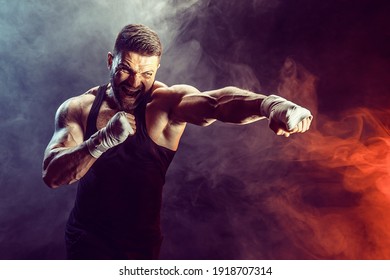 Sportsman boxer fighting on black background with shadow. Copy Space. Boxing sport concept. Smoke on background - Powered by Shutterstock