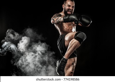 Sportsman boxer fighting on black background with smoke. Copy Space. Sport concept. - Shutterstock ID 774198586