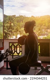 Sportsman Doing Exercises With Dumbbells At Old Gym. Athletic Asian Man Pumping Up Muscles Workout. Young Sri Lankan Bodybuilder Man Sitting And Lifting Dumbbell. Sports And Bodybuilding Concept