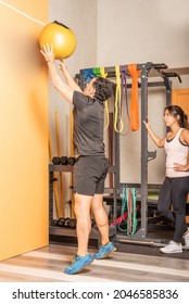 Sportsman Doing Medicine Ball Throw Exercise In Gym