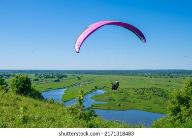 The sportsman flying on a paraglider. 
				Paragliding take off. Travel destination. Summer and holiday concept. 
