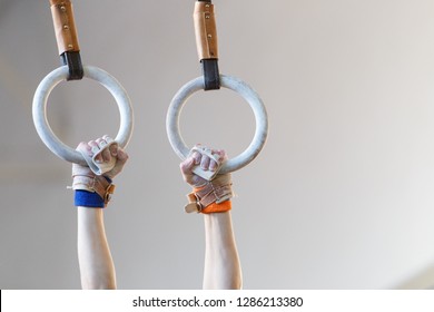 Sportsman hands with grips on gymnastic rings. - Powered by Shutterstock