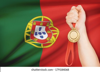 Sportsman Holding Gold Medal With Flag On Background - Portuguese Republic