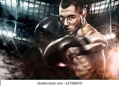 Sportsman Muay Thai Boxer Fighting In Boxing Cage. Background With Lights And Smoke. Copy Space. Sport Concept.