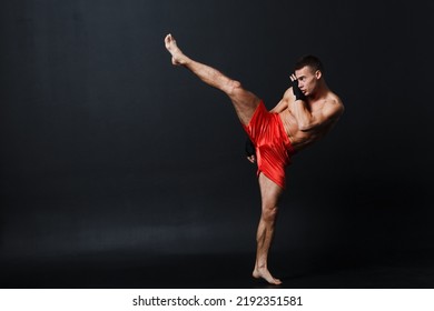 Sportsman Muay Thai Man Boxer Stance At Black Background.