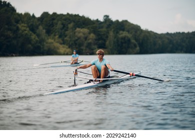 Sportsman oarsman single scull man rower rowing on boat oars. - Powered by Shutterstock