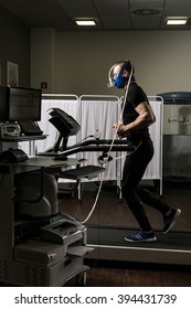 Sportsman In Oxygene Mask Running On Treadmill In Medical Office