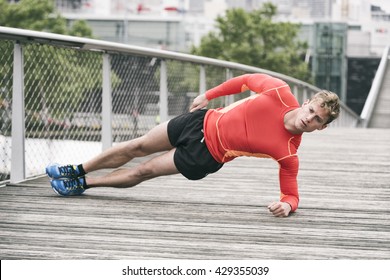 Sportsman planking exercising outside on wooden bridge - Powered by Shutterstock