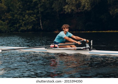 Sportsman single scull man rower rowing on boat. Paddle movement - Powered by Shutterstock