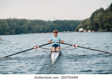 Sportsman single scull man rower rowing technique on boat. Paddle oar splash movement - Powered by Shutterstock