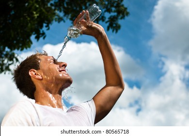 sportsman throwing water over his head for refreshment