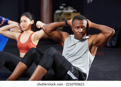 Sportsman Workout And Doing Sit Up On The Gym Floor