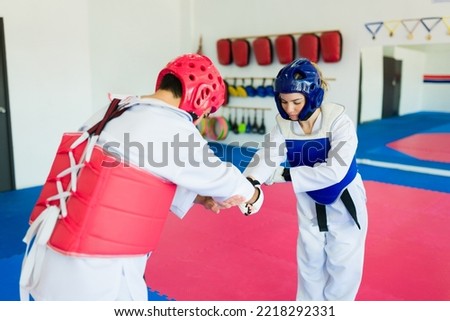 Sportsmanship concept. Taekwondo fighters finishing a martial arts or karate competition
