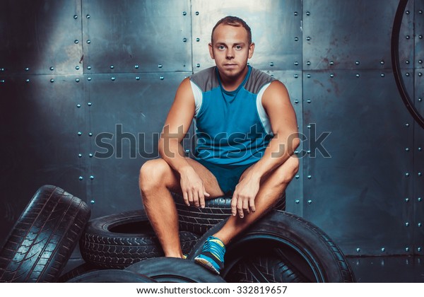 Sportsmen. fit male trainer man keeps the car tires,\
concept  fitness workout\
