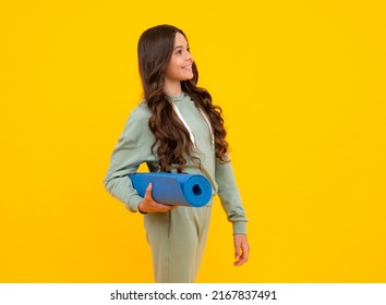 Sportswear Advertising Concept. Teenager Child Girl In Tracksuits Jogging Suit Posing In The Studio Hold Fitness Mat.