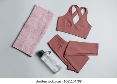 Sportswear, bottle of water and towel on grey background, flat lay. Yoga equipment - Shutterstock ID 1861134709