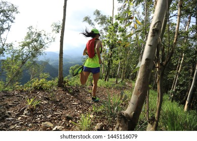 Sportswoman Cross Country Ultra Marathon Trail Runner Running In Forest