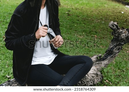 Sportswoman drinking some water from a bottle after training