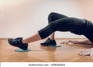 Sportswoman Exercising, Using Gliding Discs.