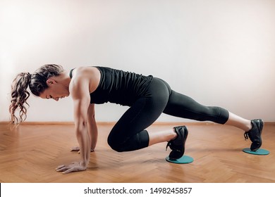 Sportswoman Exercising, Using Gliding Discs.