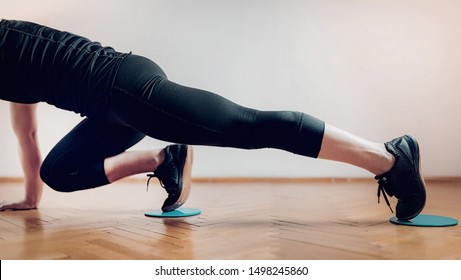 Sportswoman Exercising, Using Gliding Discs.