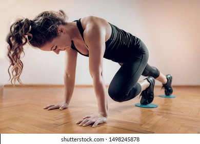 Sportswoman Exercising, Using Gliding Discs.