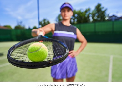 Sportswoman Holding Tennis Racquet While Standing On The Court