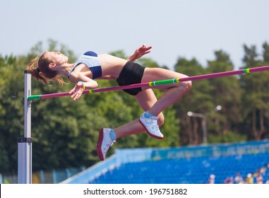 sportswoman jumps in height, sports background