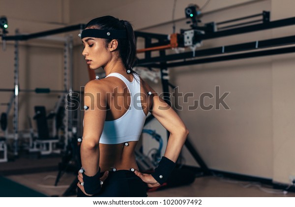 Sportswoman with\
motion capture sensors on her body to measure the movement during\
sports at biomechanical\
lab.