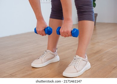 Sportswoman Practicing Aerobic With Dumbbells. Woman Lifting Weights And Working Out At Home. Healthy Lifestyle. Stay At Home Activities.