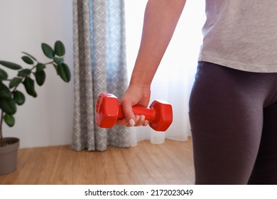 Sportswoman Practicing Aerobic With Dumbbells. Woman Lifting Weights And Working Out At Home. Healthy Lifestyle. Stay At Home Activities.