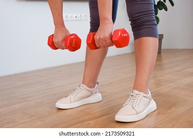 Sportswoman Practicing Aerobic With Dumbbells. Woman Lifting Weights And Working Out At Home. Healthy Lifestyle. Stay At Home Activities.