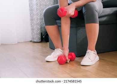 Sportswoman Practicing Aerobic With Dumbbells. Woman Lifting Weights And Working Out At Home. Healthy Lifestyle. Stay At Home Activities.