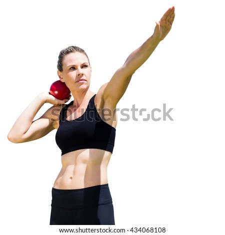 Sportswoman practicing the shot put in a white background