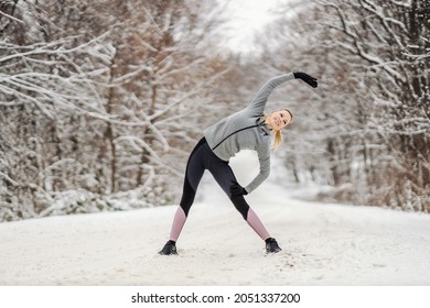 Sportswoman Standing In Nature At Winter Day And Doing Warmup And Stretching Exercises. Healthy Habits, Winter Fitness, Outdoor Fitness