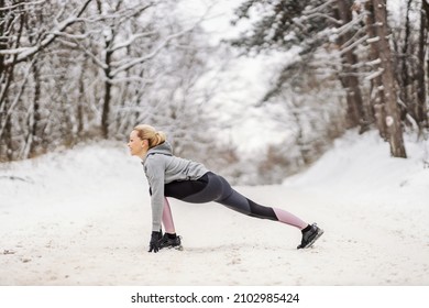 Sportswoman Standing On Snowy Path In Nature At Winter And Doing Stretching And Warmup Exercises. Healthy Life, Winter Fitness, Outdoor Fitness