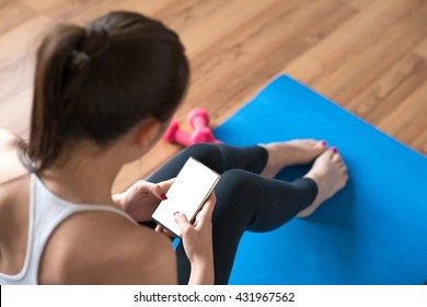 Sportswoman Using A Mobile Phone In The Gym.